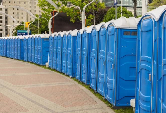 a row of portable restrooms set up for a large athletic event, allowing participants and spectators to easily take care of their needs in Brandon